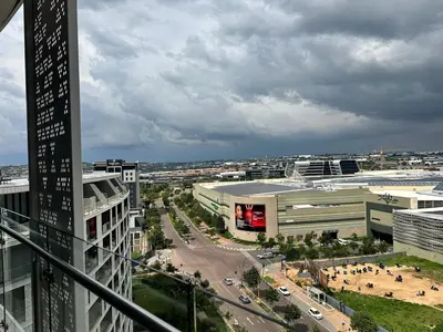 a view of a city with buildings and a street at Explore Ellipse - The Sage Apartment in Midrand