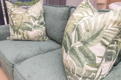 a blue couch with two pillows on it at Ellipse Soleya in Midrand