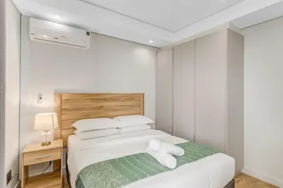 a bedroom with a bed with two towels on it at Ellipse Soleya in Midrand