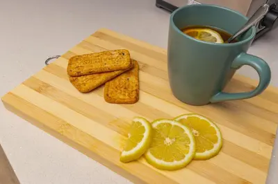 a wooden cutting board with a cup of coffee and lemon slices at Ellipse Soleya in Midrand