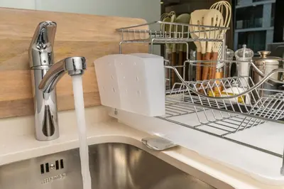 a dish drying rack on a kitchen sink at The Solace in Midrand