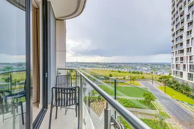a balcony with two chairs and a view of a city at The Solace in Midrand