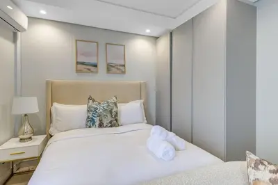 a bedroom with a large white bed and a nightstand at The Solace in Midrand