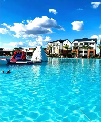 a pool of blue water with a slide in it at The Blyde Crystal Lagoons in Pretoria