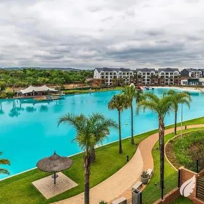an overhead view of a large swimming pool with palm trees at The Blyde Crystal Lagoons in Pretoria
