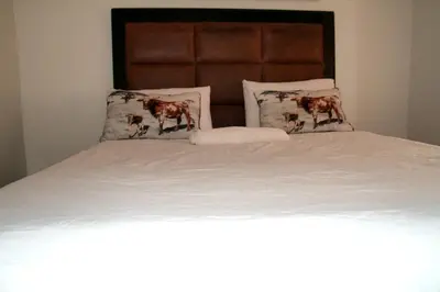a bed with two pillows with cows on it at The Blyde Crystal Lagoons in Pretoria