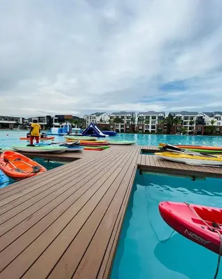 a pool with kayaks and boats on a dock at The Blyde Crystal Lagoons in Pretoria