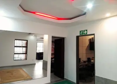 a living room with a red light on the ceiling at Sbarba guesthouse in Ga-Kgapane