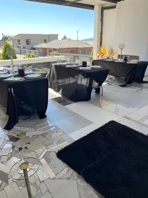 a patio with two tables with black table cloth at Sbarba guesthouse in Ga-Kgapane