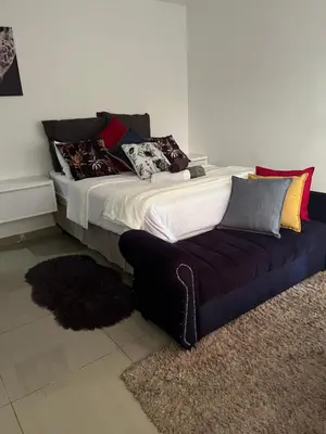 a bed and a couch in a room at Sbarba guesthouse in Ga-Kgapane