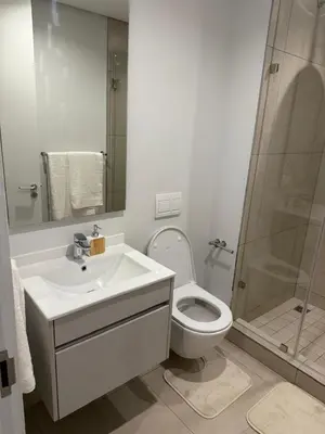 a bathroom with a toilet and a sink and a shower at Ellipse Luxary Apartment in Midrand