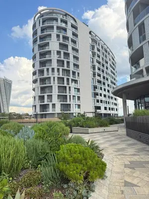 a large white building with a garden in front of it at Ellipse Luxary Apartment in Midrand