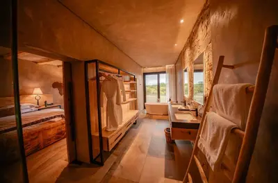 a large bathroom with a bed and a sink at Kapama River Lodge in Kapama Private Game Reserve