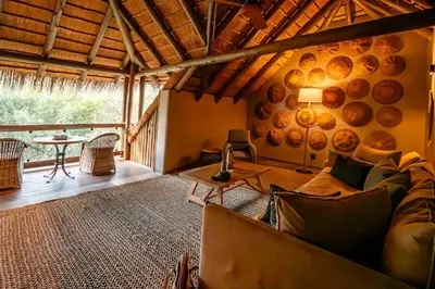 a living room with a couch and a table at Kapama River Lodge in Kapama Private Game Reserve