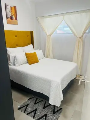 a bedroom with a white bed and a window at 2 bedroom signature luxury apartment in Midrand