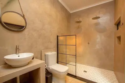 a bathroom with a toilet and a sink and a mirror at Makrugu Forest in Marloth Park
