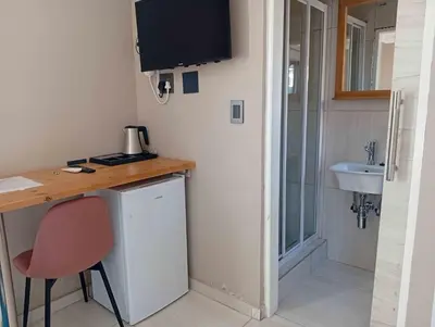 a small room with a desk and a sink at Joyful Home Bela-Bela in Bela-Bela