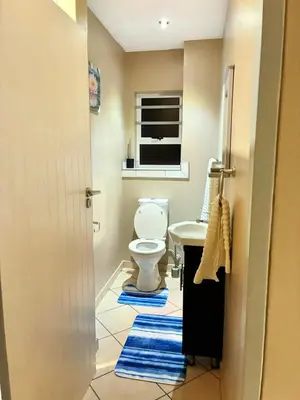 a bathroom with a toilet and a sink at Apartment with Breathtakingly Beautiful Lake Views in Pretoria