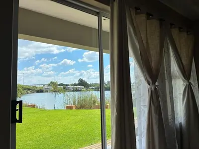 a window with a view of a body of water at Apartment with Breathtakingly Beautiful Lake Views in Pretoria