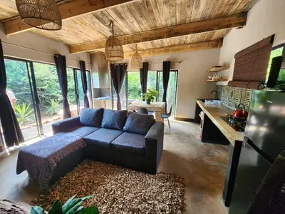 a living room with a couch and a table at Hartbeest Bush Stay #30 in Hartbeespoort