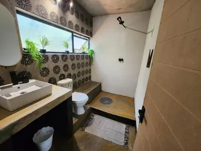 a bathroom with a sink and a toilet and a window at Hartbeest Bush Stay #30 in Hartbeespoort