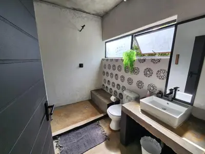 a bathroom with a white toilet and a sink at Hartbeest Bush Stay #29 in Hartbeespoort