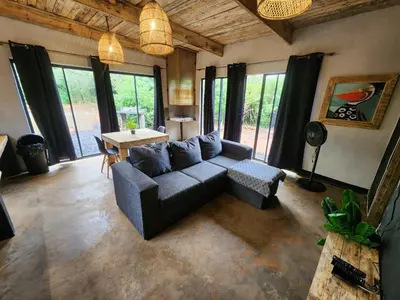 a living room with a couch and a table at Hartbeest Bush Stay #29 in Hartbeespoort