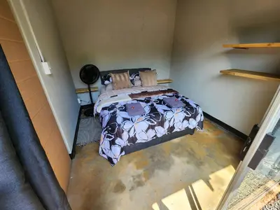 a bedroom with a bed in a room at Hartbeest Bush Stay #27 in Hartbeespoort