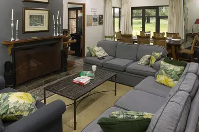a living room with couches and a coffee table at Elgin Farm Dullstroom in Dullstroom