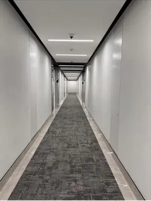 a long hallway with white walls and a long aisle at 4TEN15 Deluxe at Galileo, Ellipse in Midrand