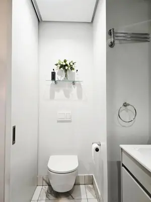 a white bathroom with a toilet and a sink at 4TEN15 Deluxe at Galileo, Ellipse in Midrand