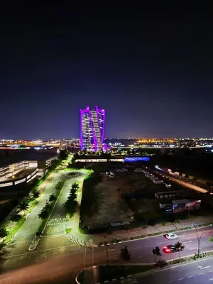a night view of a building with purple lights at 4TEN15 Deluxe at Galileo, Ellipse in Midrand