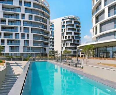 an empty swimming pool in front of two tall buildings at 4TEN15 Deluxe at Galileo, Ellipse in Midrand