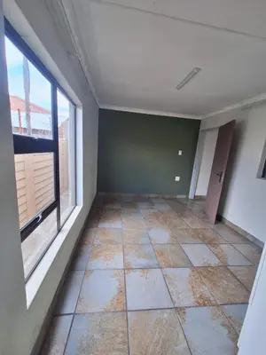 an empty room with a window and a tiled floor at Kinross house