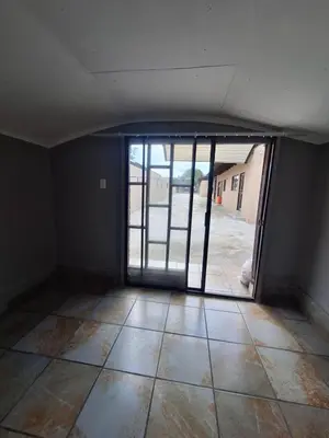 an empty room with an open door to a patio at Kinross house