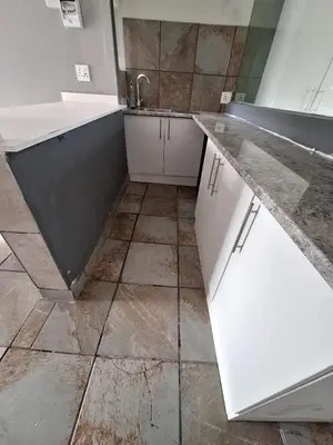 a kitchen with a sink and a tiled floor at Kinross house
