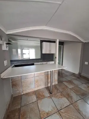 an empty kitchen with a large white counter top at Kinross house