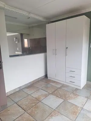 a room with white cabinets and a tile floor at Kinross house