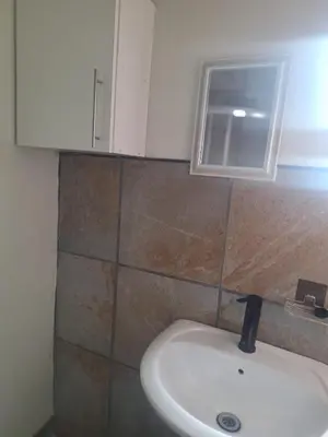 a bathroom with a sink and a window at Kinross house in Evander