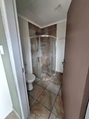 a bathroom with a shower and a toilet at Kinross house in Evander
