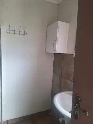 a bathroom with a sink and a white cabinet at Kinross house in Evander