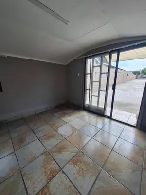 an empty room with a large window and a tiled floor at Kinross house in Evander