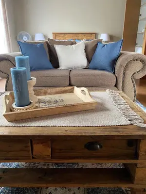a living room with a couch and a wooden coffee table at Inn Da Bush in Nelspruit