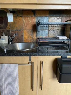 a kitchen counter with a stainless steel sink in a kitchen at Inn Da Bush in Nelspruit