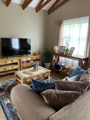 a living room with a couch and a flat screen tv at Inn Da Bush in Nelspruit