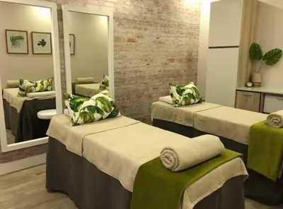 a room with three beds and a mirror at The Exquisite apartment at its best ! in Pretoria