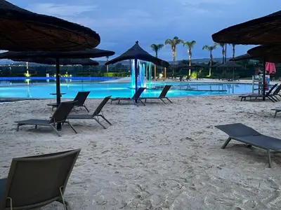 a group of chairs and umbrellas on a beach at The Exquisite apartment at its best ! in Pretoria