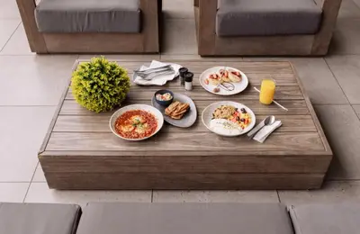 a table with plates of food on a table at Spectacular Lagoon Facing Apartment - The Blyde in Pretoria