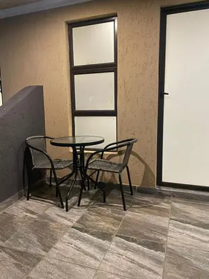 a table and two chairs in a room at Village Walk Guesthouse
