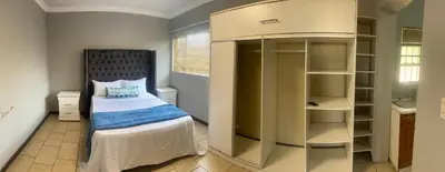 a small bedroom with a bed and a closet at Garden Flat to rent in Pretoria